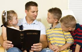 Father with children and Bible