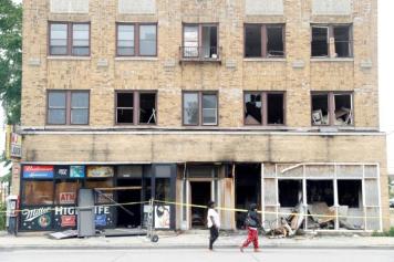 A burned down liquor store is seen after disturbances following the police shooting of a man in Milwaukee, Wisconsin